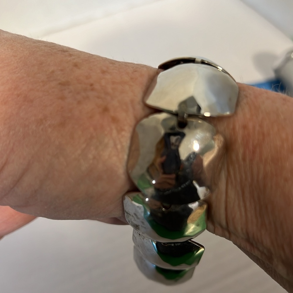 Check out this silver tone class bracelet with diamond pattern in metal